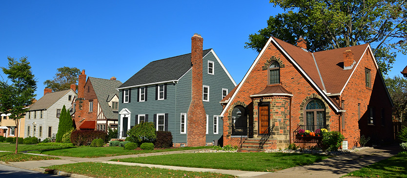 angled shot of 3 houses on an old neighborhood street